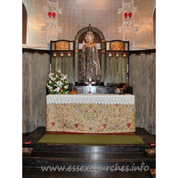 St Mary the Less, Great Warley Church – Interior 2: The chancel lower-wall is covered with a grey-green marble, and the ribbed vault is a metallic colour. The centrepiece of the reredos is a striking figure of Christ. No question of what our attention should be grabbed by here then!