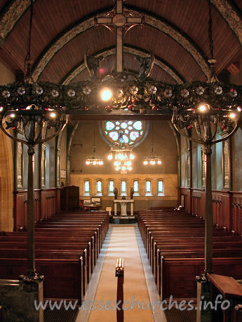 St Mary the Less, Great Warley Church – The view west gives us our first proper glimpse of the magnificent W rose window, by Heywood Sumner. The church's website gives some more information on this artist. Also present, but rather shaded in this view, is the magnificent chancel screen, shown more clearly (though not fully) in the Miscellaneous area.