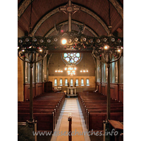 St Mary the Less, Great Warley Church – Interior 5: The view west gives us our first proper glimpse of the magnificent W rose window, by Heywood Sumner. The church's website gives some more information on this artist. Also present, but rather shaded in this view, is the magnificent chancel screen, shown more clearly (though not fully) in the Miscellaneous area.