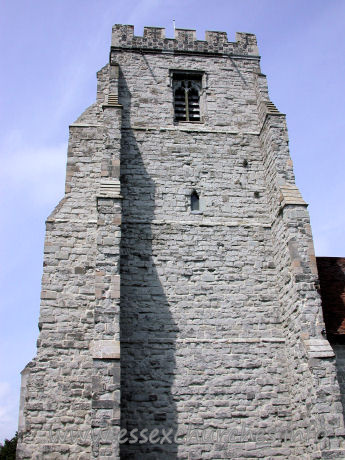 St Nicholas, Canewdon Church – This tower is of grey dressed ragstone. It has four stages, with angle buttresses, and battlements a stone and flint chequered pattern.