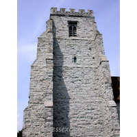 St Nicholas, Canewdon Church – Exterior 2: This tower is of grey dressed ragstone. It has four stages, with angle buttresses, and battlements a stone and flint chequered pattern.