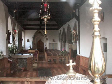 St Peter & St Paul, Hockley Church – This shot of the interior was taken through the east window, looking in above the altar. The four-bay arcade leading into a narrow N aisle can be seen to the right of the picture. The triangularly-headed door at the W end sits within a ogee-shaped W doorway.