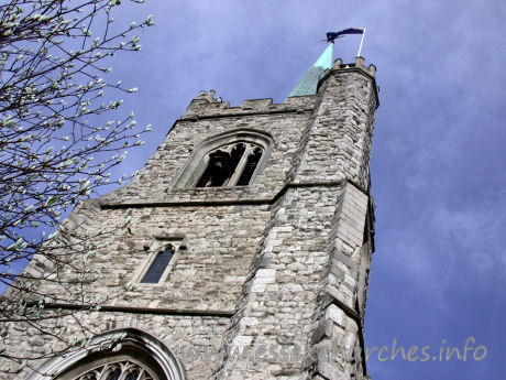 St Andrew, Hornchurch Church – This view directly up the W front of the tower shows the sheer height of the spire and tower combined. Note the small bell across the top window.