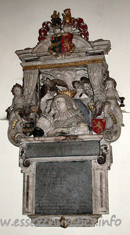 St Edmund, Abbess Roding Church – Monument to Lady Luckyln d.1633, consisting of a frontal demi-figure, with the head resting on one elbow, with a book in the foreground. Behind, two cherubs hold open a curtain. The monument has been attributed to Epiphanius Evesham, by J. Seymour.