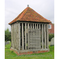 All Saints, Wrabness Church – Exterior 5: This is the Wrabness bell tower. Though it is really more of a bell cage. It is likely dated in either C17 or C18. Pevsner describes it as being like a village lock-up.