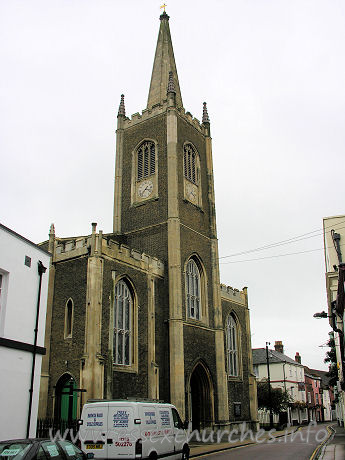 St Nicholas, Harwich Church – Yellow brick, tall W tower with spire. castellated porches l. and r.