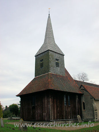 St Margaret of Antioch, Margaretting Church – My visit was on rather a gloomy looking day, but, despite the darkness, the sheer size of the tower is easily discerned. Like nearby Blackmore, the tower sits on ten posts. Three pairs of arched braces connect free standing posts in the N-S direction, whilst from E-W, the posts are spanned by lower and smaller arched braces.