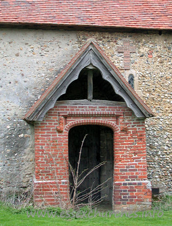 Dedication Unknown, Mashbury Church – This tudor brick porch was built approx 1500. The roof of both this porch, and the nave are C15. Note the obsured Norman window, and the cross shape, formed from tiles.