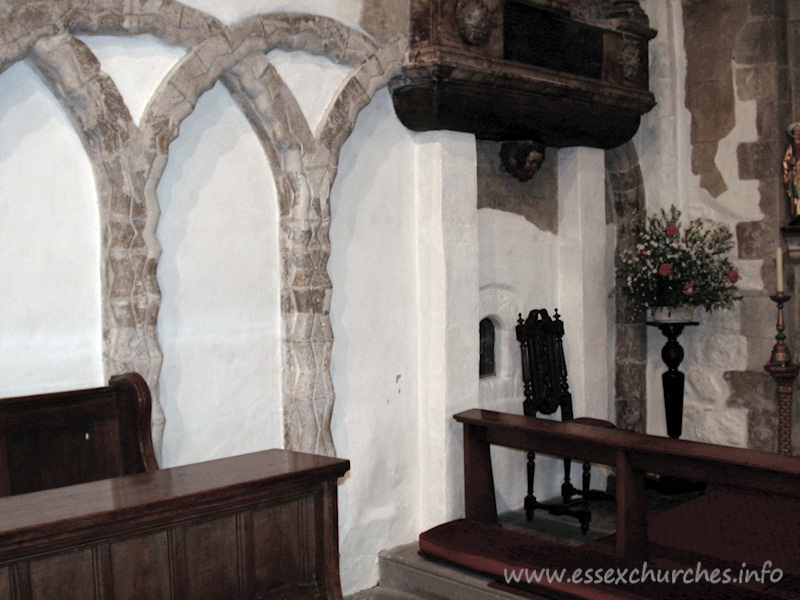 St Mary Magdalene, East Ham Church – The north nave wall. Note the glazed aperture to the left of the chair. This is the anchorite's cell.