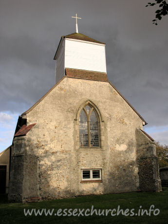 St James, Little Clacton Church – This view of the west end of the church could be a view of a remote parish church. That it isn't! The belfry sits on four posts with tie-beams and curved braces.