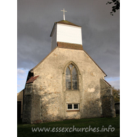 St James, Little Clacton Church – Exterior 3: This view of the west end of the church could be a view of a remote parish church. That it isn't! The belfry sits on four posts with tie-beams and curved braces.