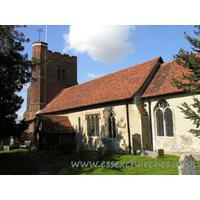 All Saints, Nazeing Church – Exterior 2: A similar shot, though this time showing a little of the external chancel wall. The Norman nave window is clearly visible, just to the right of the porch. The fine C16 tower is also evident here, with it's blue diapering, battlements and raised stair turret.