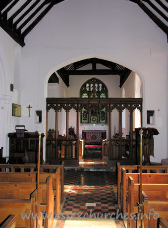All Saints, Nazeing Church – The chancel arch, with screen. The two strange objects to either side of the arch are the remains of the rood screen supporting structure. Higher, and to the left, can be seen the remains of the rood beam.
