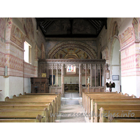 St Michael & All Angels, Copford Church – Interior 1: Looking towards the chancel, from the W end of the nave. Clearly visible here are four springers, which once supported the Norman barrel vaulting. Two can be seen either side of the screen, whilst the other two are clearly visible at both upper corners of the image.
